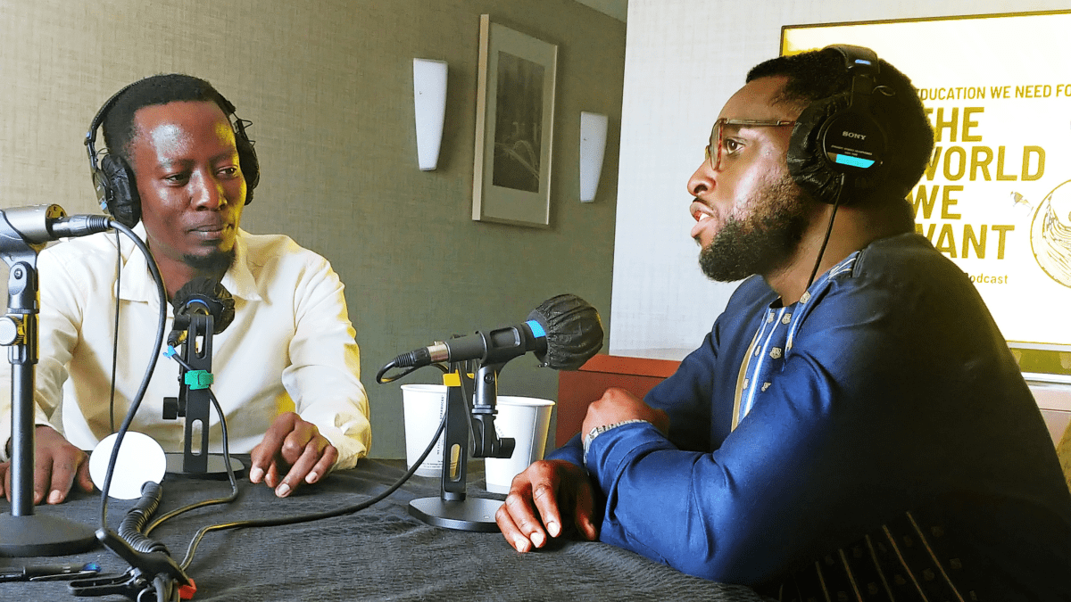 Ritchie Tusabe and Harrison Ashangwa wear headphones as they are interviewed for The World We Want podcast