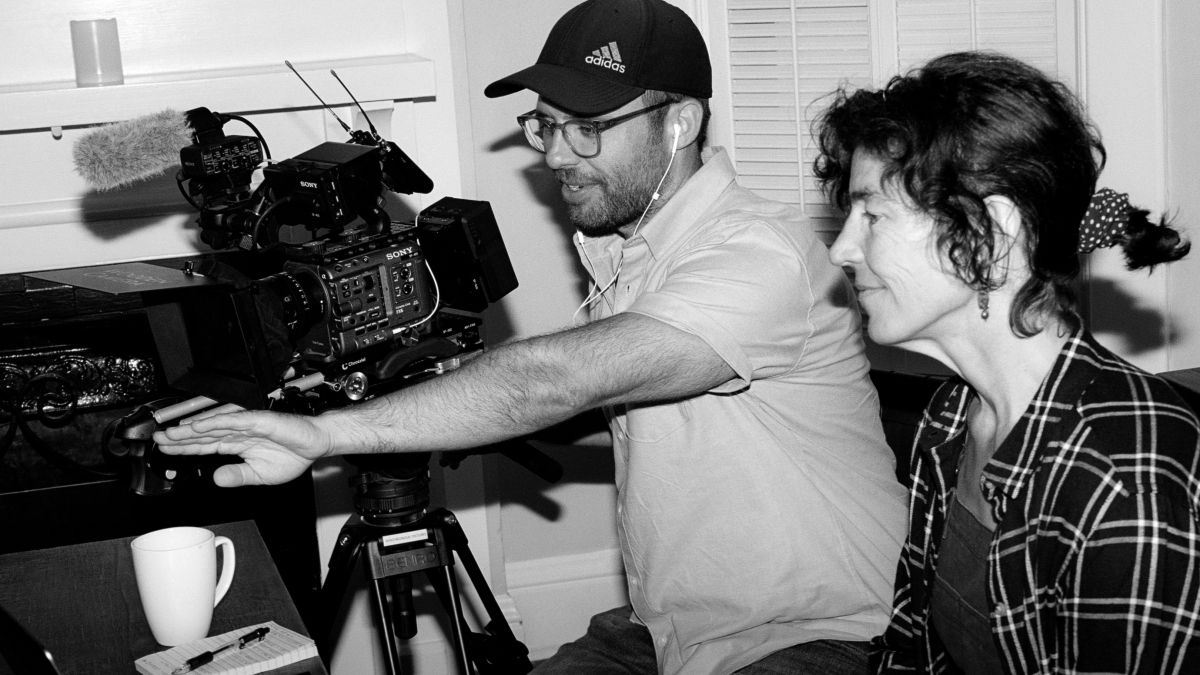 James Parker and Juliet Grable look through a camera while making a documentary